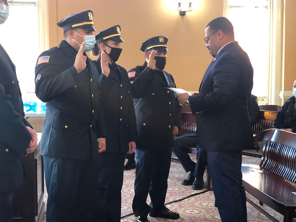 (L-R) Officers Angelo Yonnone, Jessica Brooks and Daniel D’Elicio are sworn in by Mayor Torrance Harvey as new sergeants in the City of Newburgh Police Department.